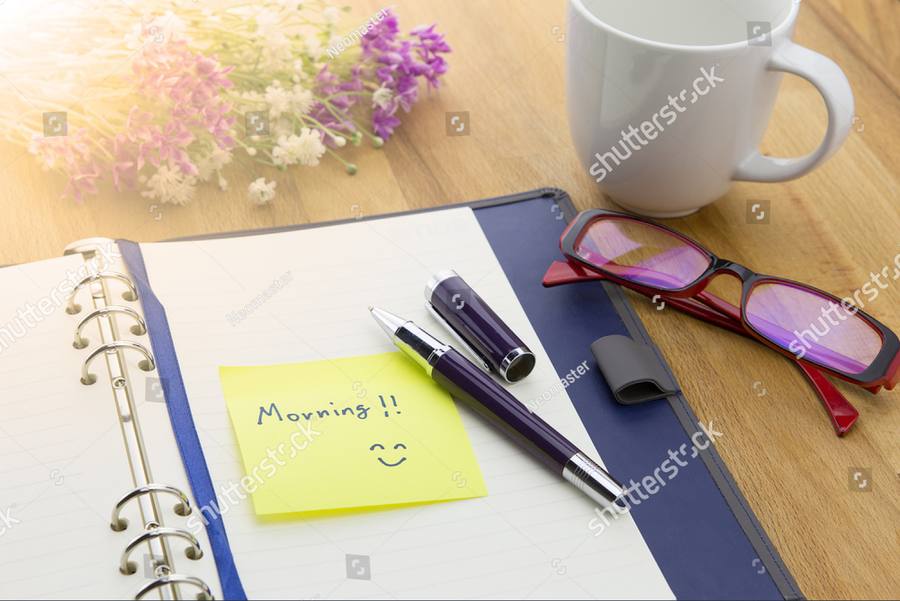 A pen resting on an open notebook