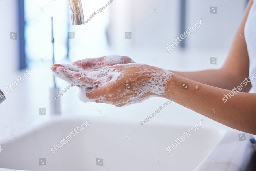 Hands being washed under a running tap