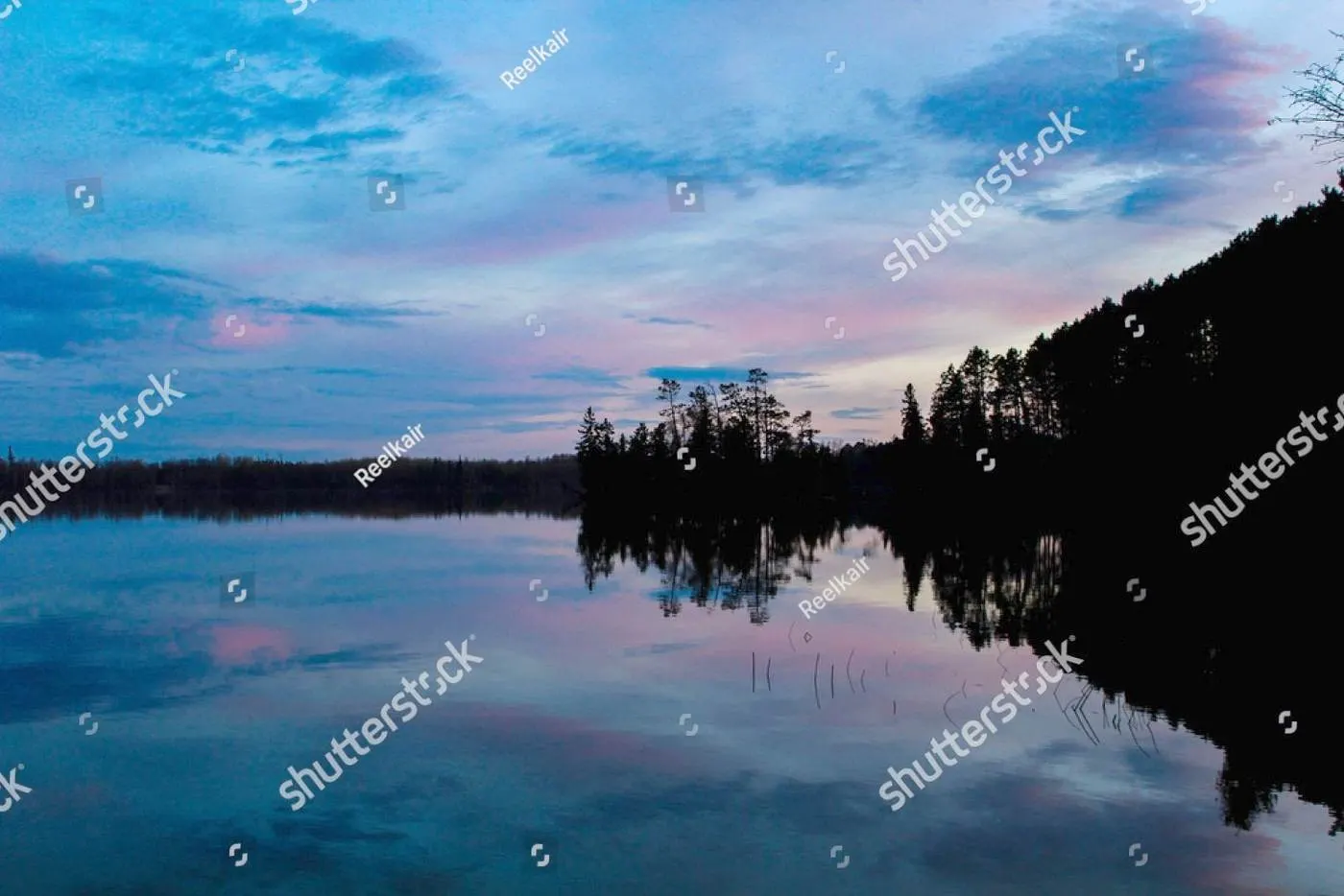 Deep blue and violet twilight over a still Minnesota lake